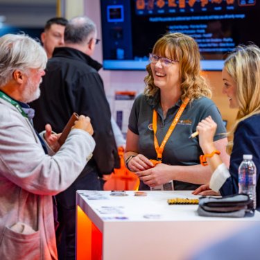 Exhibitors chat with an Infosecurity Europe attendee